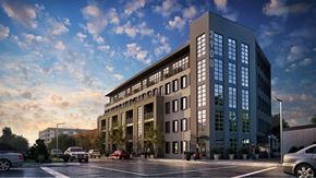 Richmond apartment for rent - A modern building with a parking lot in front of it.