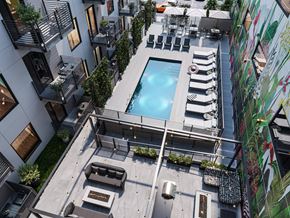 Richmond apartment for rent - A modern outdoor pool area with lounge chairs and a hot tub.