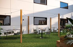 Richmond apartment for rent - A patio with a table and chairs is set up outside a white building.