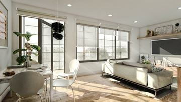 Richmond apartment for rent - A modern living room with a white sofa and a dining table with chairs.