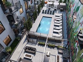 Richmond apartment for rent - A modern outdoor pool area with lounge chairs and a fire pit.