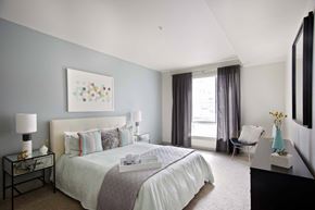 Portland apartment for rent - A bedroom with a large bed and a painting on the wall.