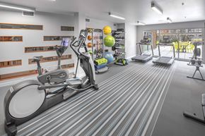 Portland apartment for rent - A gym with a treadmill, elliptical trainer, and other exercise equipment.
