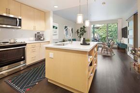 Portland apartment for rent - A modern kitchen with wooden cabinets and a large island.