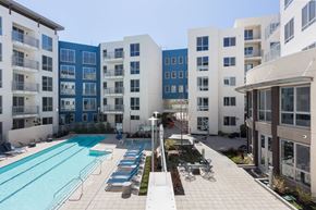Foster City apartment for rent - A swimming pool surrounded by apartment buildings.