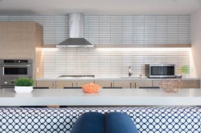 Foster City apartment for rent - A modern kitchen with a stove top oven and a microwave above it.