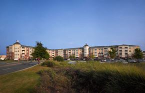 Chesapeake apartment for rent - A row of apartment buildings with a clear blue sky above.