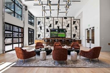 Denver apartment for rent - A modern living room with a large screen tv and comfortable seating.