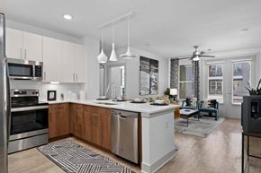 Denver apartment for rent - A modern kitchen with wooden cabinets and stainless steel appliances.