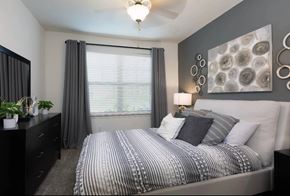 Frisco apartment for rent - A bedroom with a large bed and a chandelier.