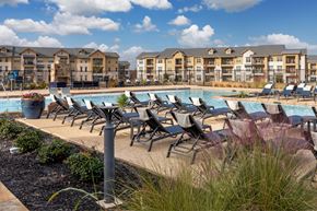 Frisco apartment for rent - A row of sun loungers are on the edge of a pool.