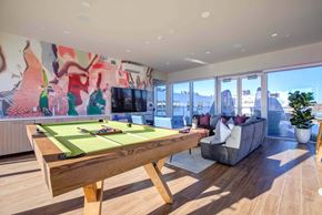 Seattle apartment for rent - A pool table in a room with a couch and a plant.