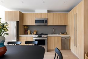 New York apartment for rent - A modern kitchen with wooden cabinets and stainless steel appliances.