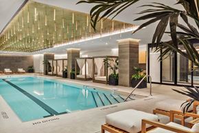 New York apartment for rent - A large indoor swimming pool with a wooden lounge area.
