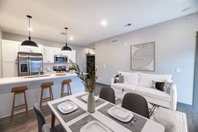 Grandville apartment for rent - A modern dining room with a table set for four.