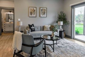 Grandville apartment for rent - A grey couch with a white throw on it sits in a living room.