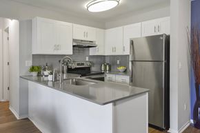 Ann Arbor apartment for rent - A kitchen at Villas at Northstar apartment for rent in Ann Arbor, MI with white cabinets and breakfast bar.