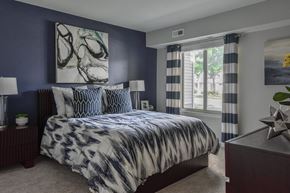 Ann Arbor apartment for rent - Bedroom with large windows and décor at The Villas at Northstar Ann Arbor apartments for rent.