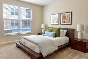 Westerville apartment for rent - A bedroom with a large bed and two lamps.