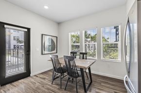 Tampa apartment for rent - A dining room with a table and chairs and a fridge.