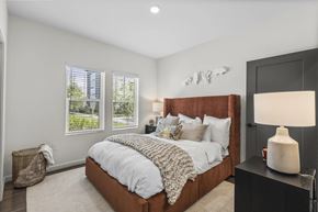 Tampa apartment for rent - A bedroom with a large bed and a lamp on a side table.