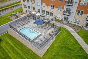 Cottage Grove apartment for rent - A swimming pool surrounded by a fence in a grassy area.