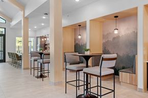 Rochester apartment for rent - A modern dining area with a table surrounded by chairs.