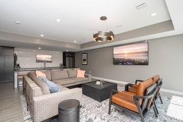 West Saint Paul apartment for rent - A modern living room with a large couch and a television.