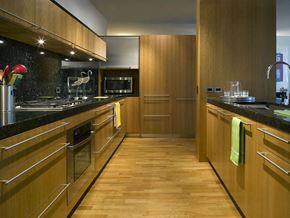 Skokie apartment for rent - A kitchen with wooden cabinets and a black counter top.