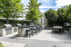 Chicago apartment for rent - A patio with tables and chairs surrounded by trees.