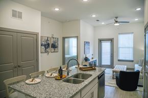 Gonzales apartment for rent - A kitchen with a table and chairs and a sink.