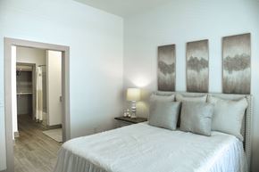 Gonzales apartment for rent - A bedroom with a large bed and three framed pictures on the wall.