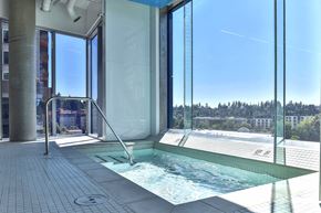 Bellevue apartment for rent - A hot tub is located on a patio with a glass wall.