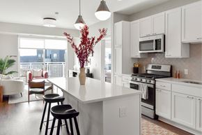 Hopkins apartment for rent - Bright kitchen with large white island and bar seating at The Hallon apartments for rent in Hopkins, Minnesota