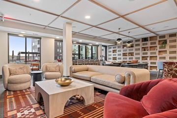 Hopkins apartment for rent - A living room with a red couch and a wooden coffee table.