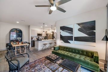 Chandler apartment for rent - A living room with a green velvet sofa and a dining table with chairs.