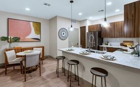 Chandler apartment for rent - A kitchen with a bar area and a dining table set up.