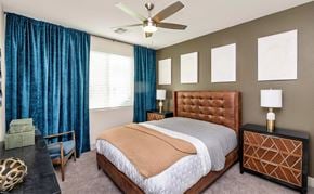 Chandler apartment for rent - A bedroom with a large bed and a ceiling fan.