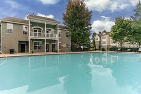 Jonesboro apartment for rent - Resort-style pool with backdrop of Monterey Village apartments for rent in Jonesboro, Georgia.