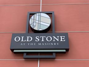 Richmond apartment for rent - A sign for Old Stone at the Masonry is mounted on a wall.