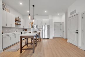 Williamsburg apartment for rent - A modern kitchen with a wooden table and chairs.