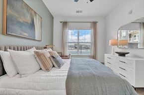 Williamsburg apartment for rent - A bedroom with a large bed and a painting on the wall.