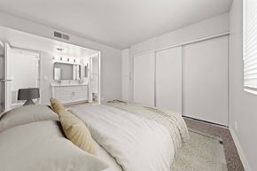 Mesa apartment for rent - Bedroom with bed, dresser, and a mirror at Station 21 apartments for rent in Mesa.