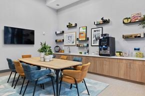 West New York apartment for rent - A modern dining room with a wooden table and chairs.