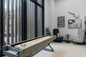 West New York apartment for rent - A pool table in a room with a chair, a plant, and pictures on the wall.