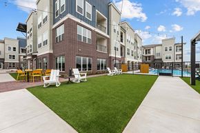 Fort Worth apartment for rent - A large building with a pool in the backyard.