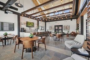 Colorado Springs apartment for rent - A modern dining room with wooden furniture and a stone floor.