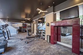 Richmond apartment for rent - A gym with a variety of equipment including treadmills, weights, and exercise machines.