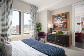 Phoenix apartment for rent - A bedroom with a large bed and a framed picture on the wall.