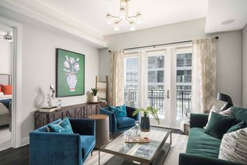 Phoenix apartment for rent - A living room with a blue sofa and a green couch.